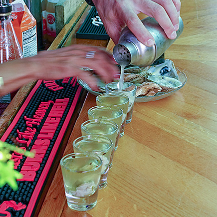 Readying oyster shots with the hot pepper-infused Tequila