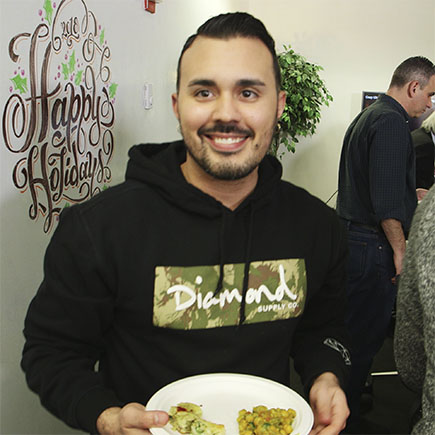 Victor Vasquez flashes a smile at our 2018 holiday potluck lunch