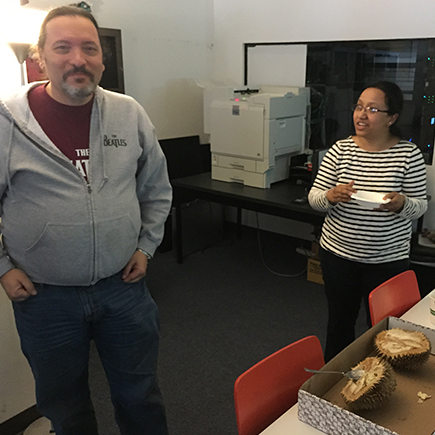 Warren and Heema prepare to eat a piece of the Durian fruit.