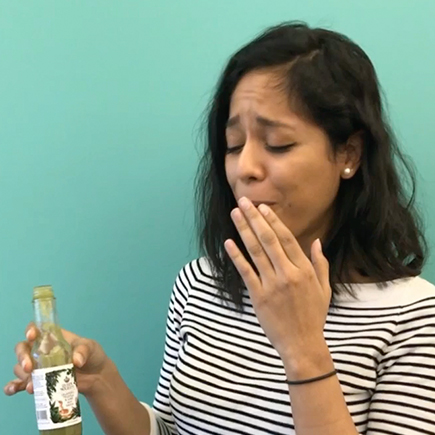 Ana needs a glass of water after trying one of our hot sauces.