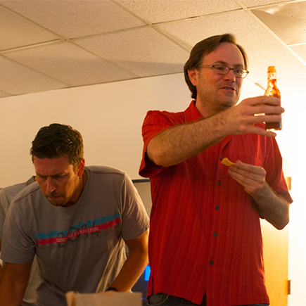 Dodd holds up a bottle of hot sauce.