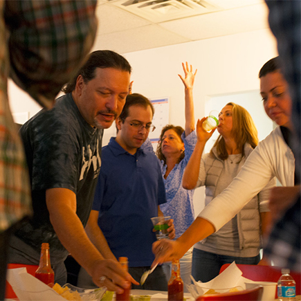 Warren dips his chip in some hot sauce.