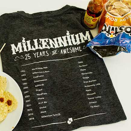 Top down shot of the Anniversary T-shirt(back) along with some hot sauce and chips.